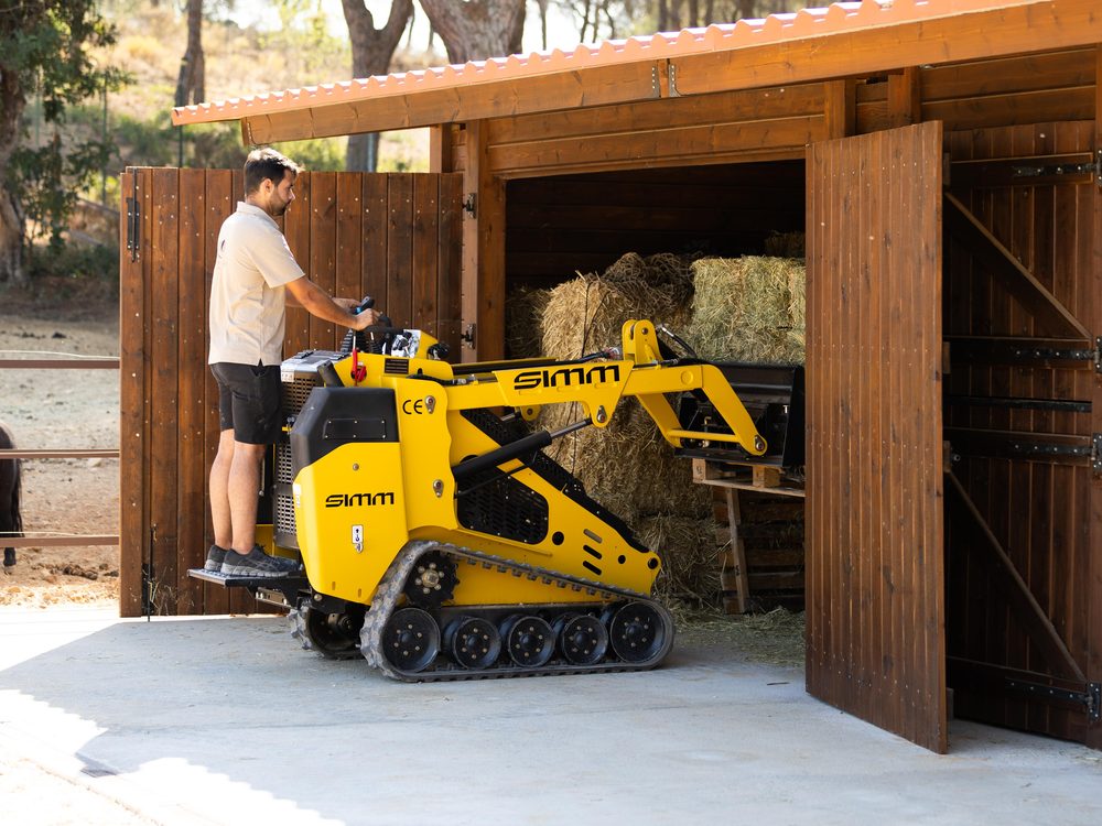 Prime Hay unloader driving hay into a stable barn