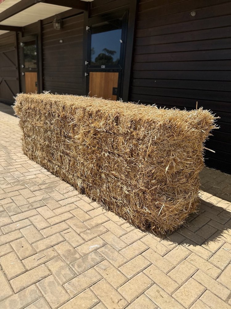 A big bale of Portuguese wheat straw at a stable yard